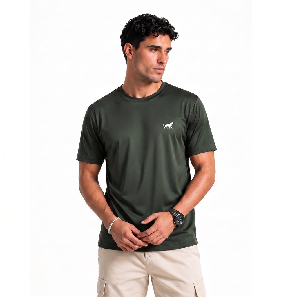A man wearing a dark olive green short-sleeve athletic t-shirt with a smal  wolf logo on the left chest, paired with beige cargo pants, against a plain white background.