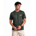A man wearing a dark olive green short-sleeve athletic t-shirt with a smal  wolf logo on the left chest, paired with beige cargo pants, against a plain white background.